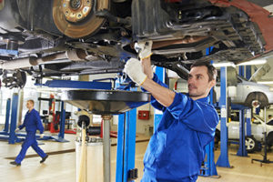auto-mechanic-at-car-suspension-repair-work-300x200.jpg