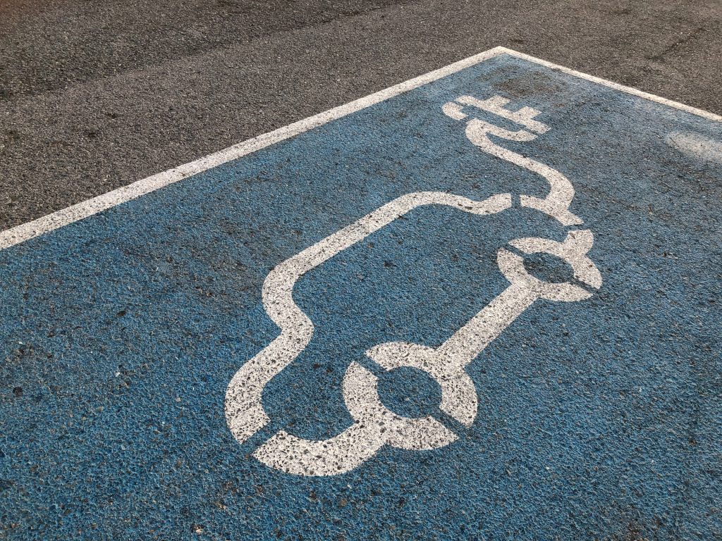 electric-car-parking-red-dot-iy8h-Cl8MLc-unsplash-1024x768.jpg