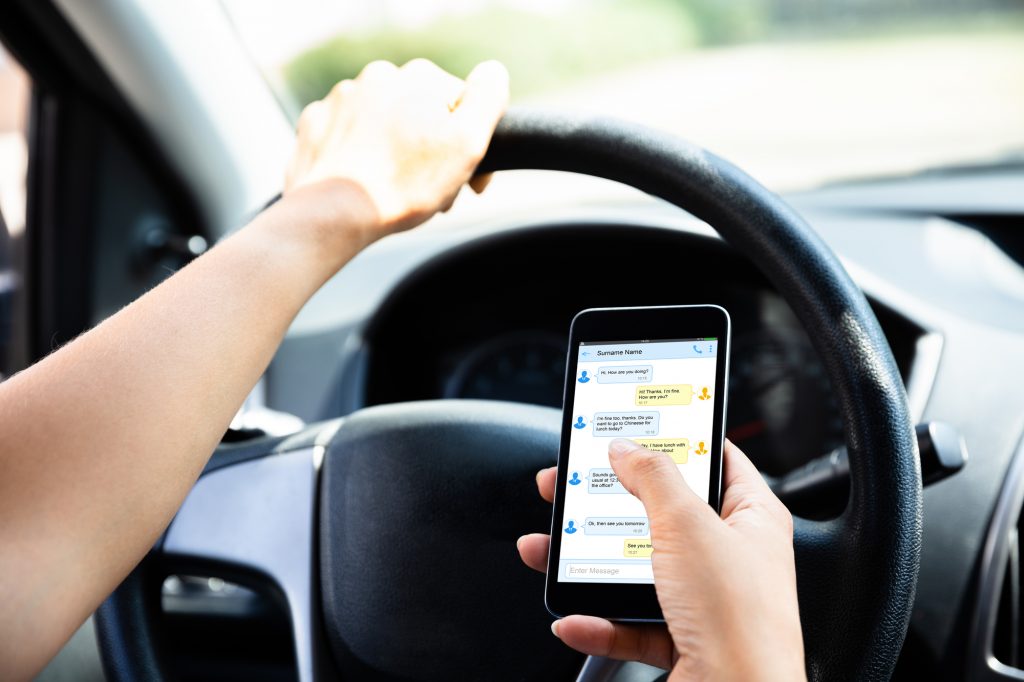 Distracted-driving-cell-smart-phone-Depositphotos_219589628_L-1024x682.jpg