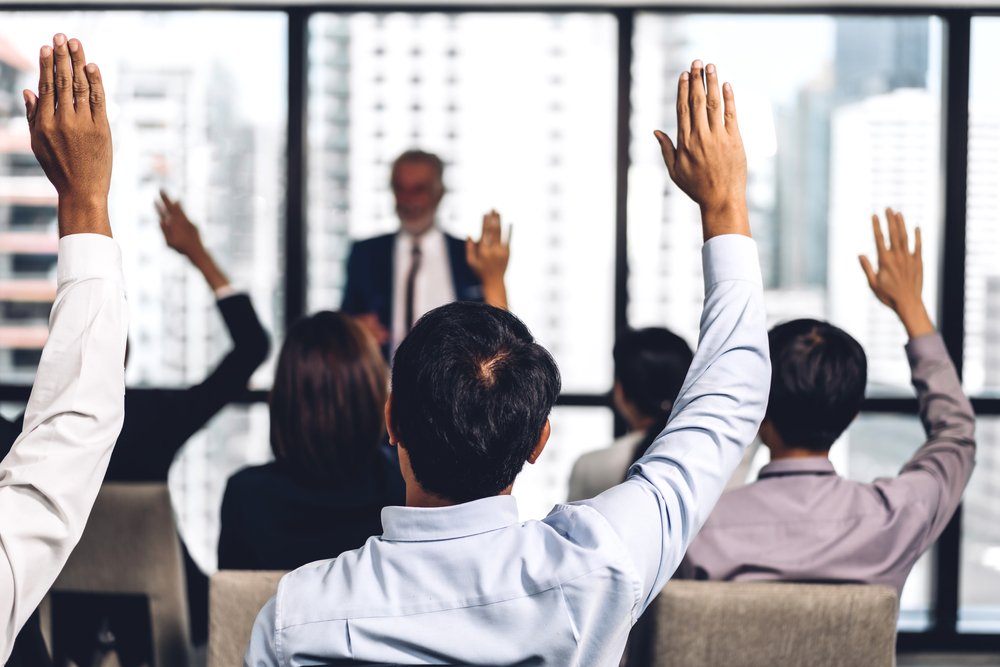 Shareholders-vote-questions-answer-QA-raise-hands-Depositphotos_317419084_S.jpg